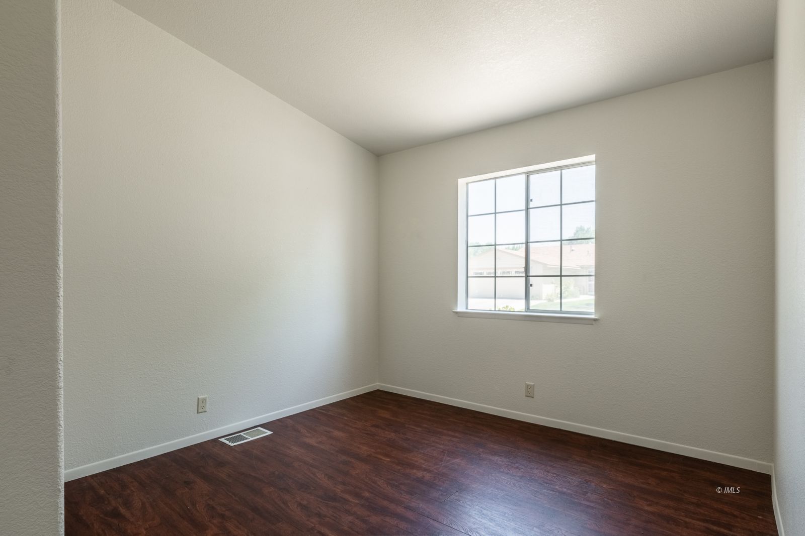 77 Olivia Lane Big Pine, CA 93513 - Photo 18 of 35 an empty room with wooden floor and windows