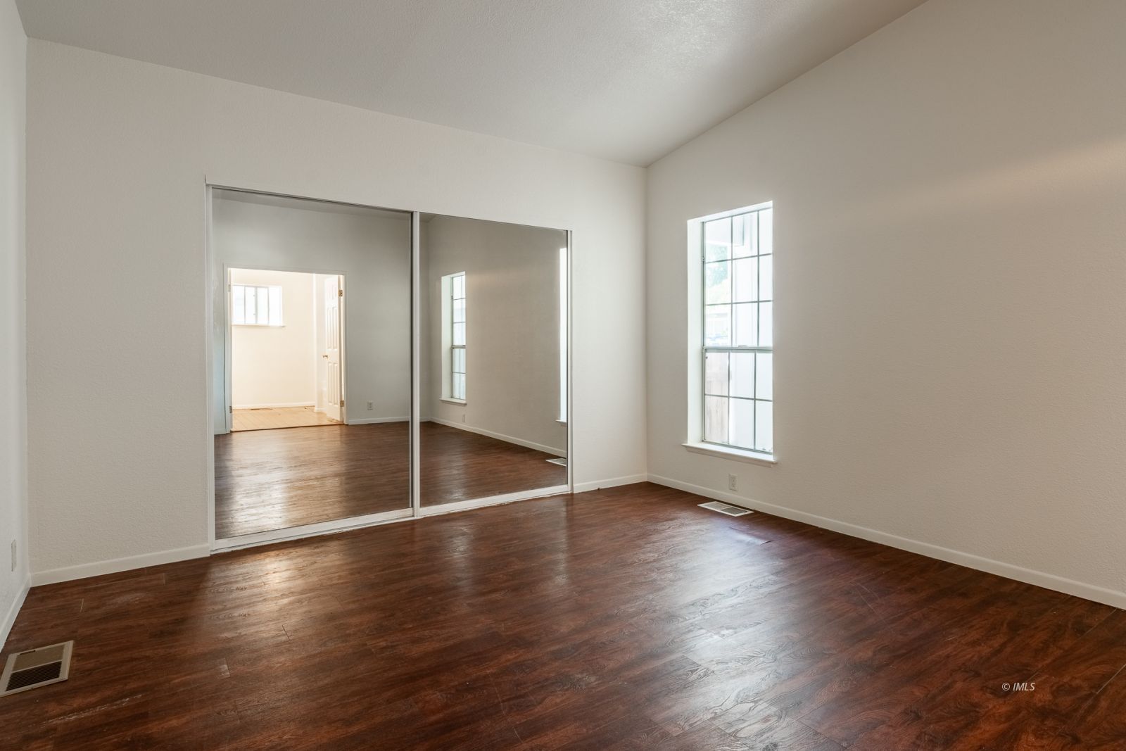 77 Olivia Lane Big Pine, CA 93513 - Photo 20 of 35 an empty room with wooden floor and windows