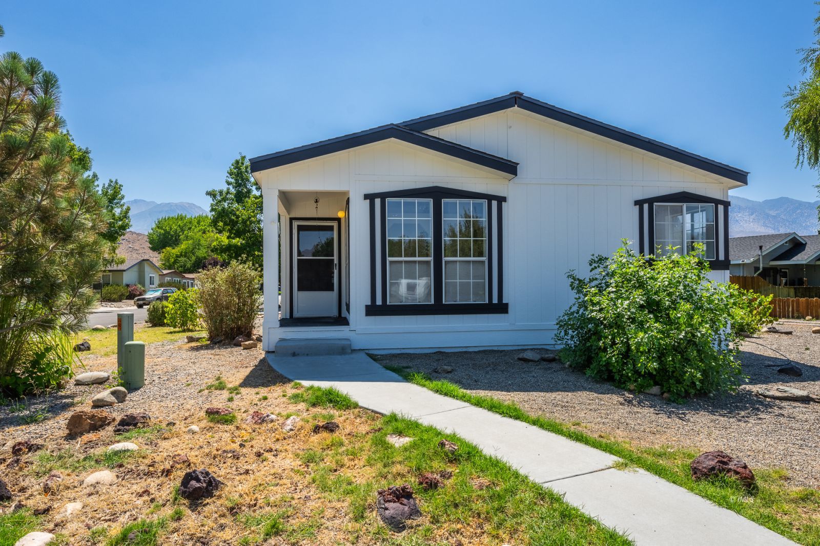 77 Olivia Lane Big Pine, CA 93513 - Photo 2 of 35 a front view of a house with garden
