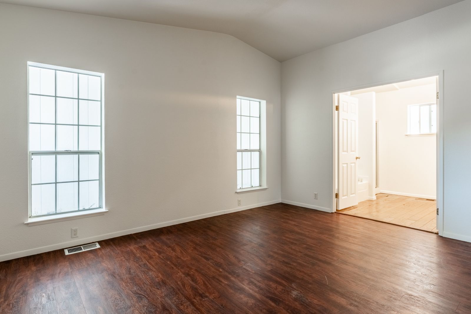 77 Olivia Lane Big Pine, CA 93513 - Photo 21 of 35 an empty room with wooden floor and windows