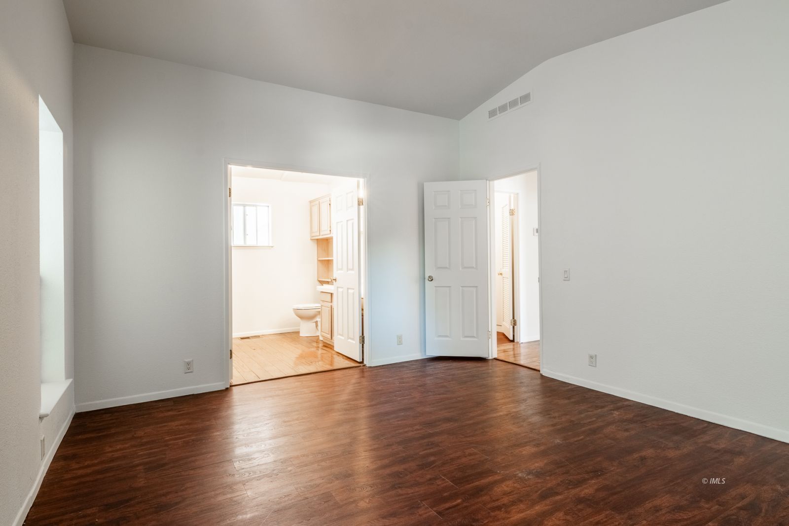 77 Olivia Lane Big Pine, CA 93513 - Photo 22 of 35 an empty room with wooden floor and natural light