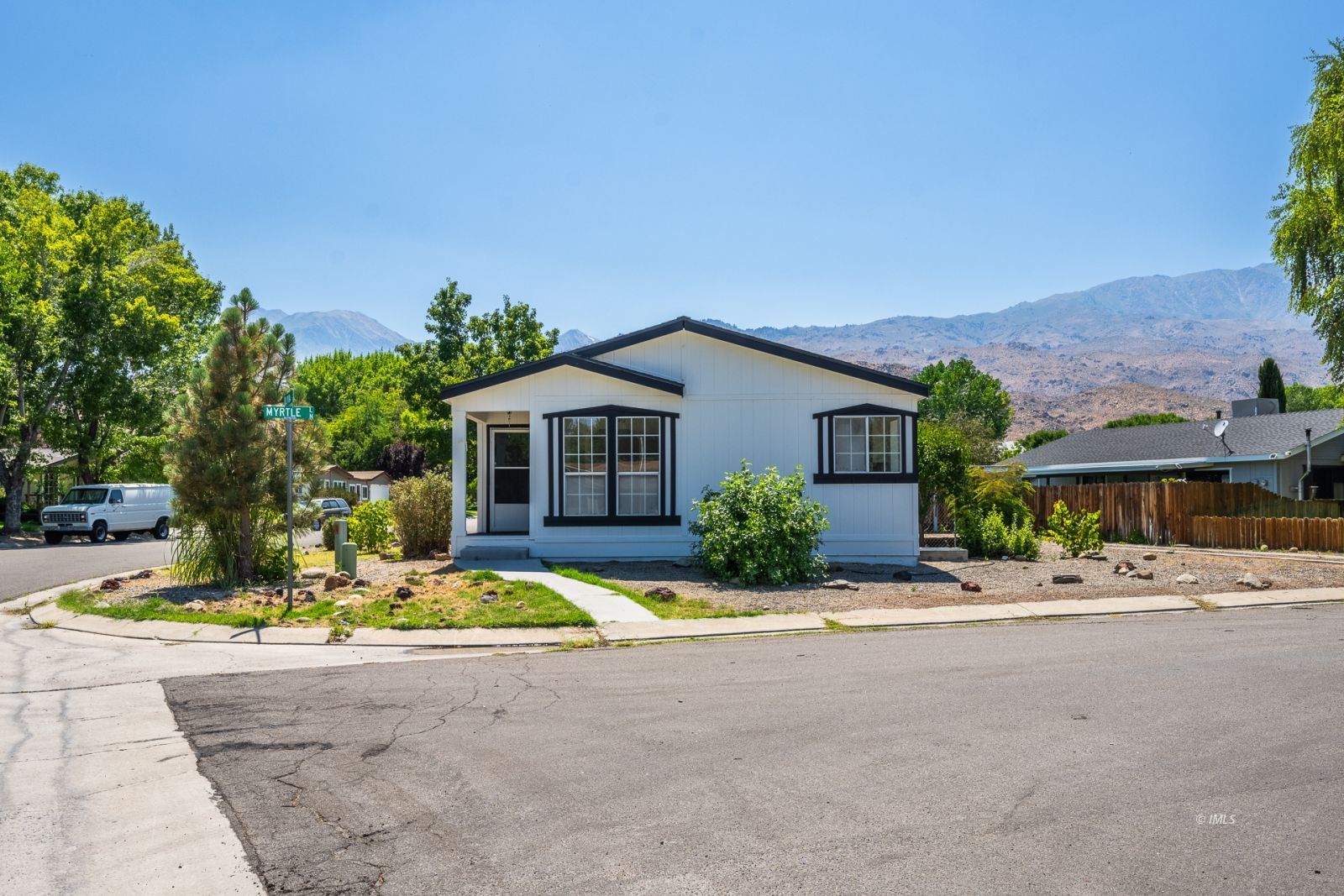 77 Olivia Lane Big Pine, CA 93513 - Photo 3 of 35 a view of a house with small yard and plants