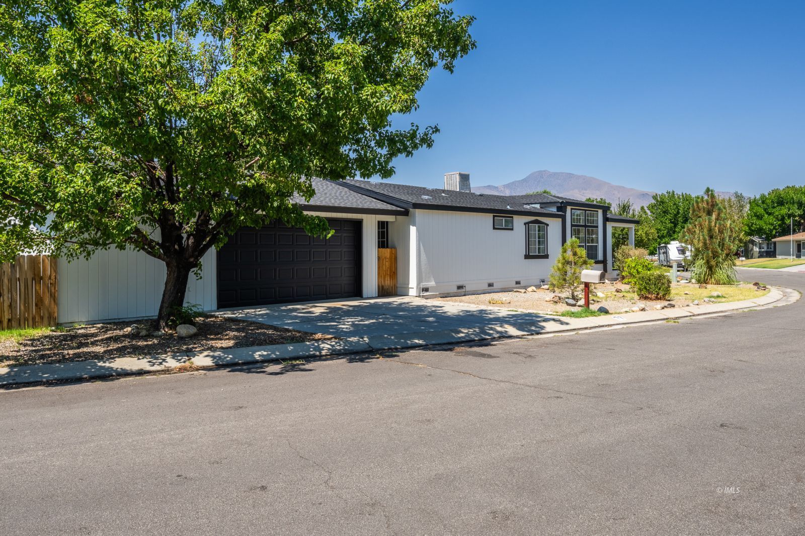 77 Olivia Lane Big Pine, CA 93513 - Photo 5 of 35 a view of the house with backyard and trees