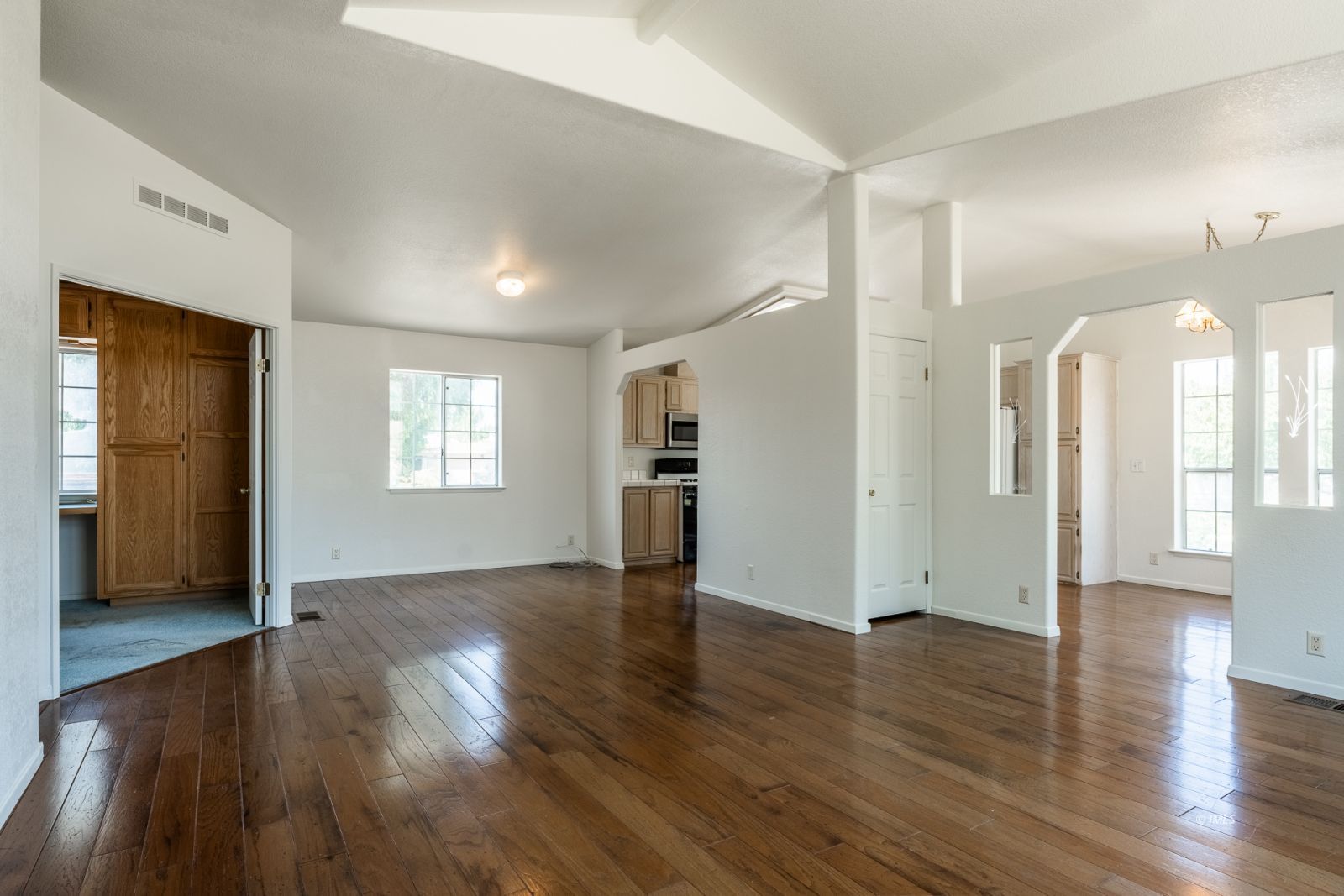 77 Olivia Lane Big Pine, CA 93513 - Photo 7 of 35 an empty room with wooden floor and windows