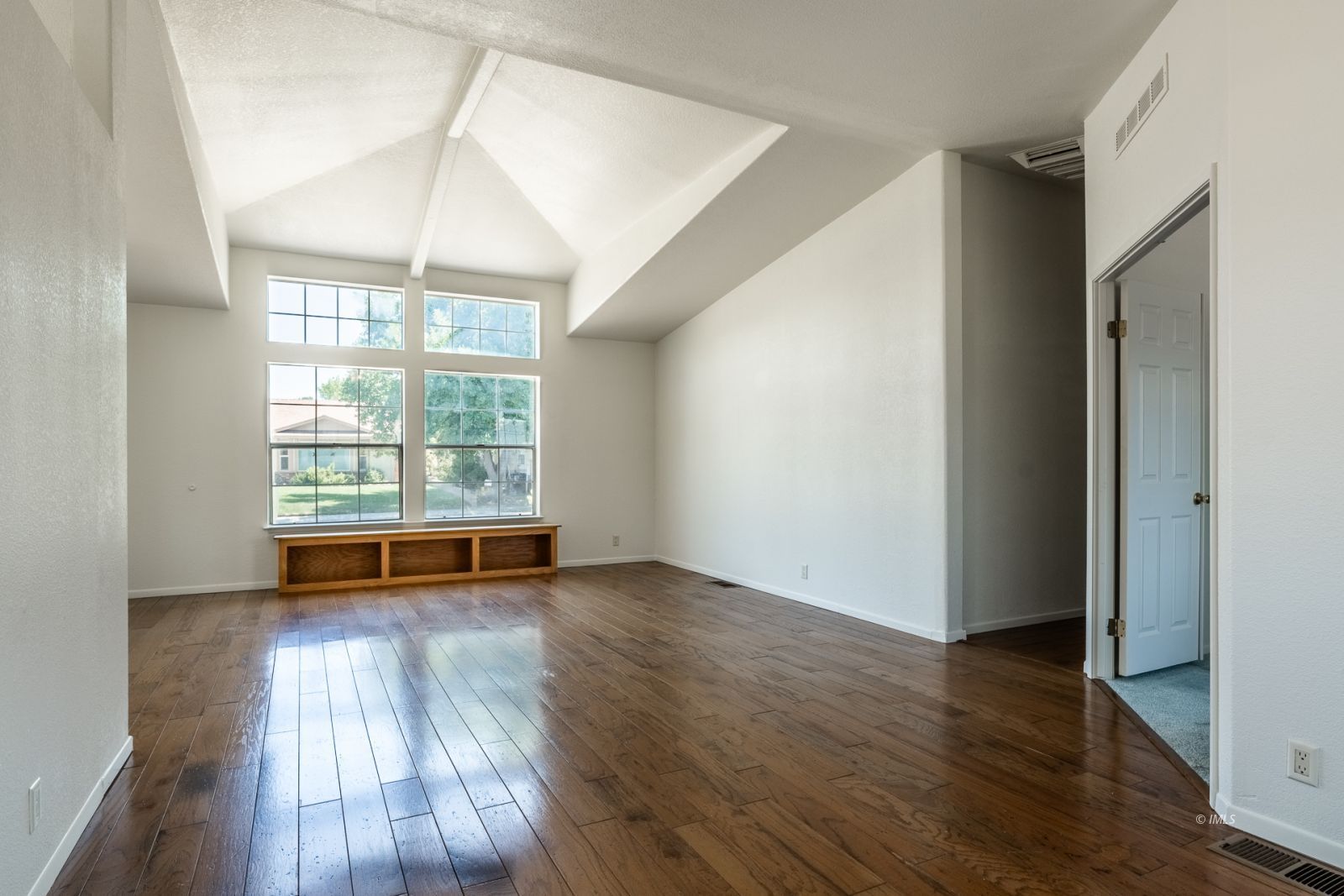 77 Olivia Lane Big Pine, CA 93513 - Photo 10 of 35 an empty room with wooden floor and windows