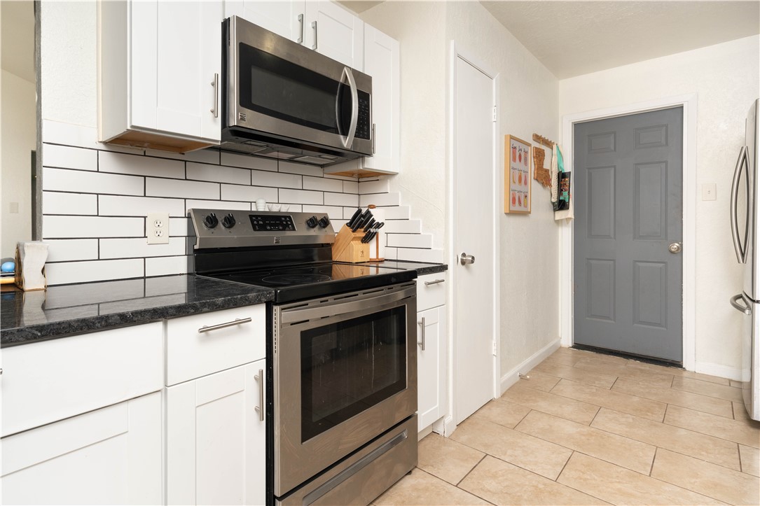 9566 Waxwing Street Corpus Christi, TX 78418 - Photo 12 of 20 a kitchen with stainless steel appliances a stove and a microwave