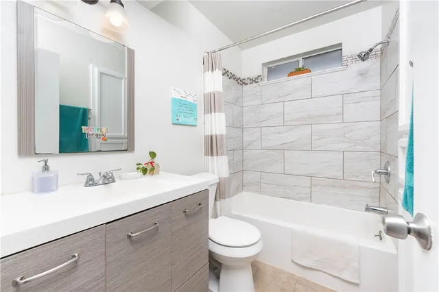 a living room with furniture and a book shelf