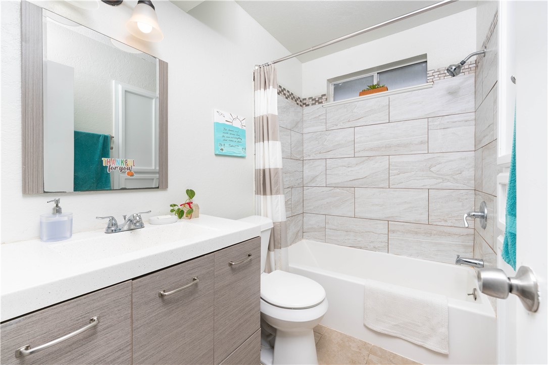 9566 Waxwing Street Corpus Christi, TX 78418 - Photo 15 of 20 a bathroom with a sink a toilet and shower