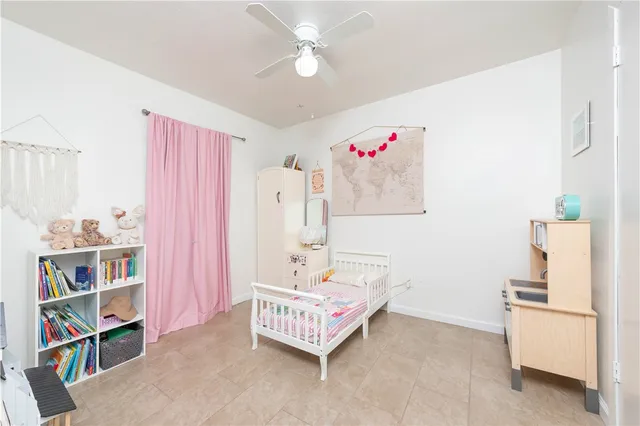 a spacious bedroom with a bed and a cabinets