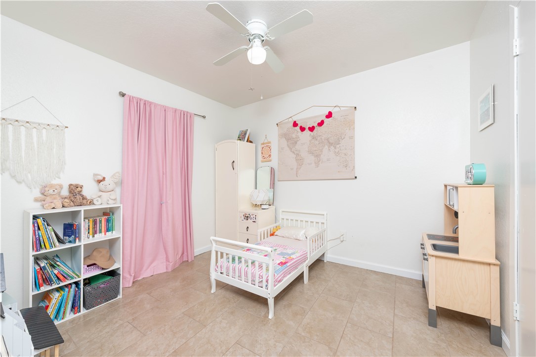 9566 Waxwing Street Corpus Christi, TX 78418 - Photo 16 of 20 a living room with furniture and a book shelf