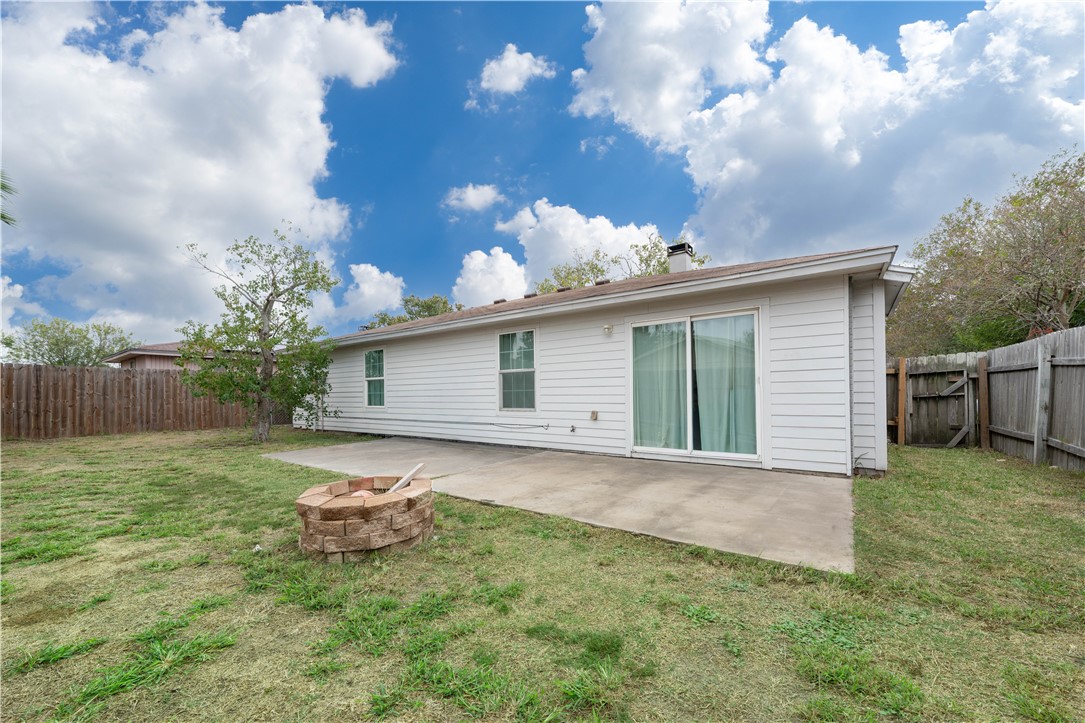 9566 Waxwing Street Corpus Christi, TX 78418 - Photo 19 of 20 a backyard of a house with table and chairs