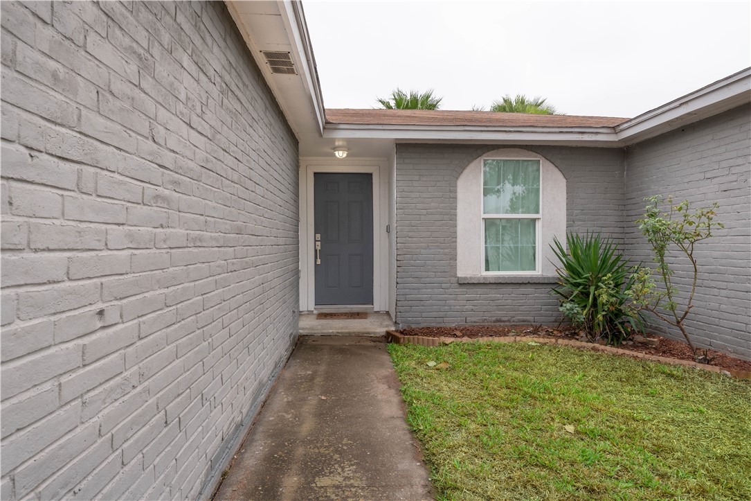 9566 Waxwing Street Corpus Christi, TX 78418 - Photo 4 of 20 a front view of a house with a garden