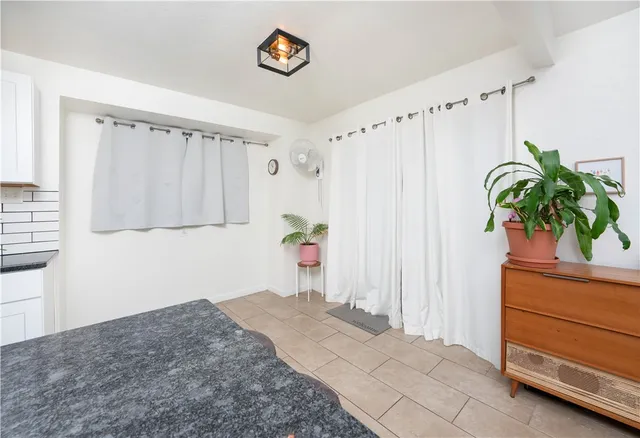 a kitchen with stainless steel appliances a white cabinets and a potted plant