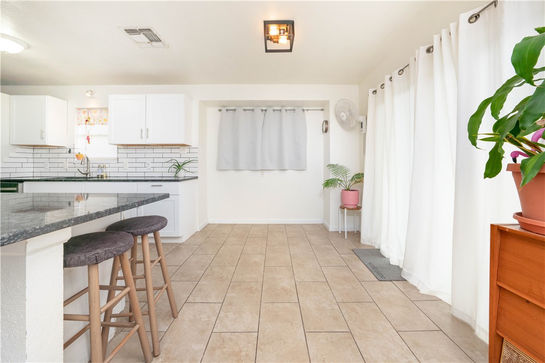 9566 Waxwing Street Corpus Christi, TX 78418 - Photo 9 of 20 a kitchen with stainless steel appliances a white cabinets and a potted plant