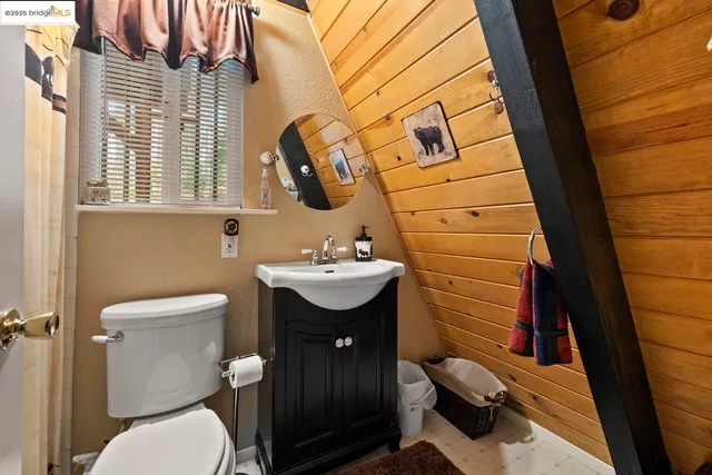 a bathroom with a sink toilet and mirror