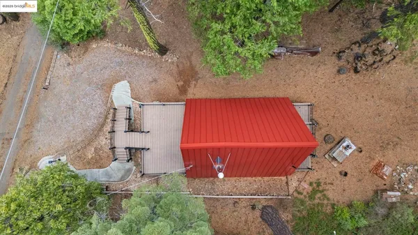 an aerial view of a house with garden space and street view