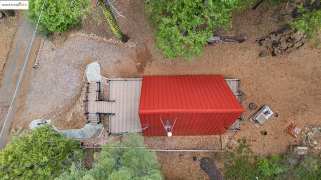 an aerial view of a house with garden space and street view