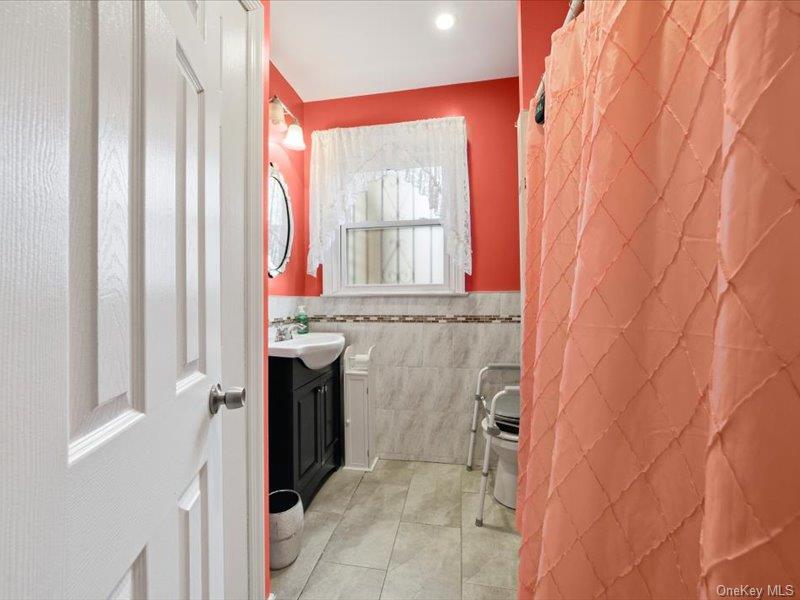 3330 Eastchester Road Bronx, NY 10469 - Photo 11 of 39 a bathroom with a sink and a shower