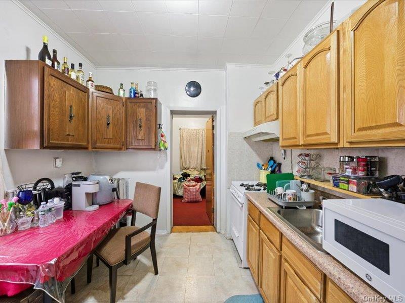 3330 Eastchester Road Bronx, NY 10469 - Photo 12 of 39 a kitchen with stainless steel appliances granite countertop a refrigerator and a stove top oven
