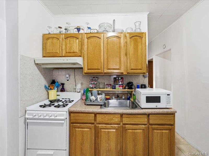 3330 Eastchester Road Bronx, NY 10469 - Photo 14 of 39 a kitchen with stainless steel appliances granite countertop a sink and cabinets