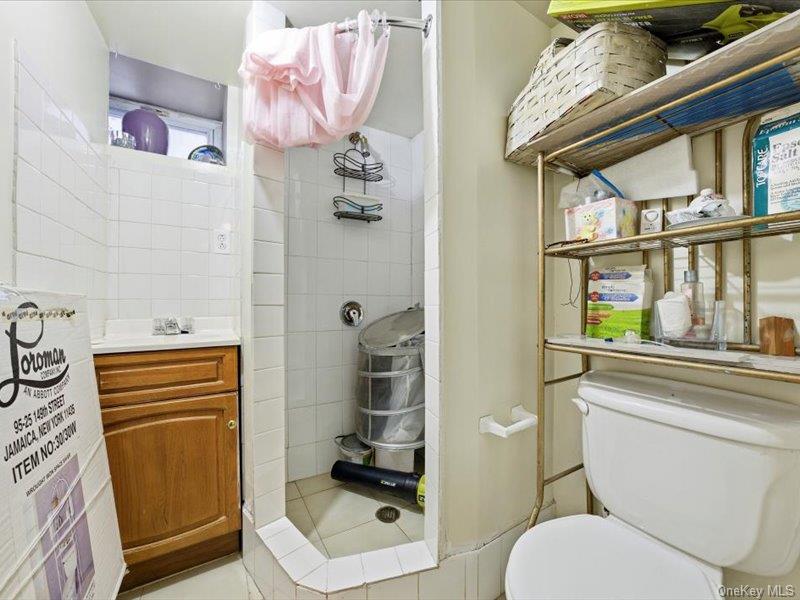 3330 Eastchester Road Bronx, NY 10469 - Photo 18 of 39 a bathroom with a sink a toilet and shower