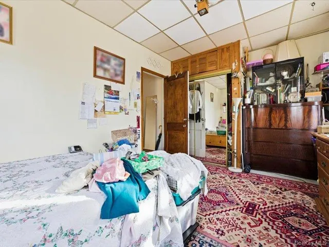 a bedroom with furniture and a flat screen tv