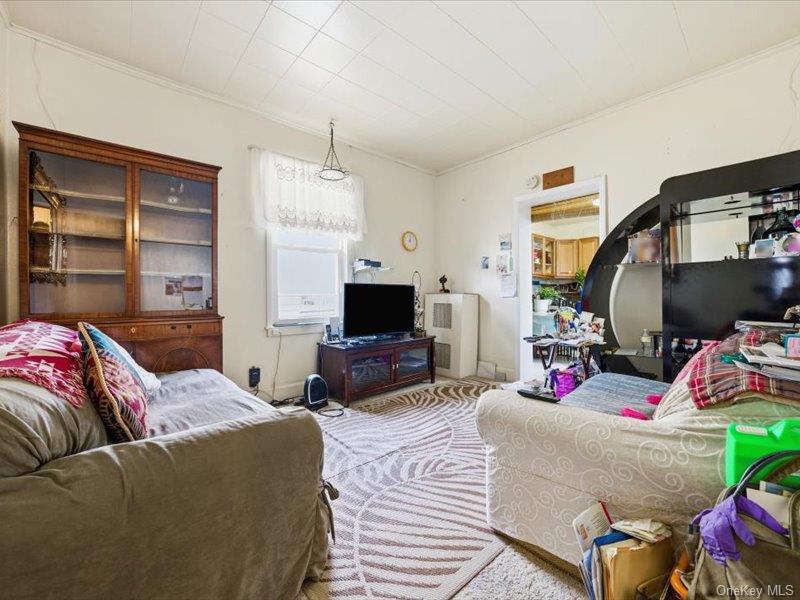 3330 Eastchester Road Bronx, NY 10469 - Photo 25 of 39 a living room with furniture a flat screen tv and a fireplace