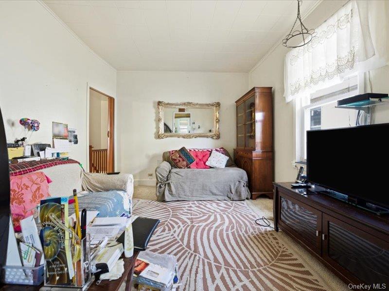 3330 Eastchester Road Bronx, NY 10469 - Photo 26 of 39 a bedroom with furniture and a flat screen tv