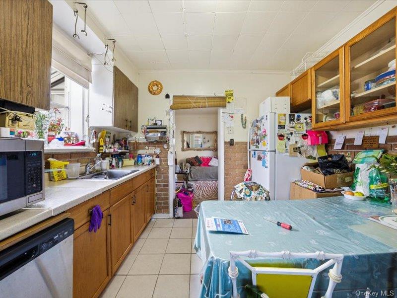 3330 Eastchester Road Bronx, NY 10469 - Photo 28 of 39 a kitchen filled with a white stove top oven and cabinets