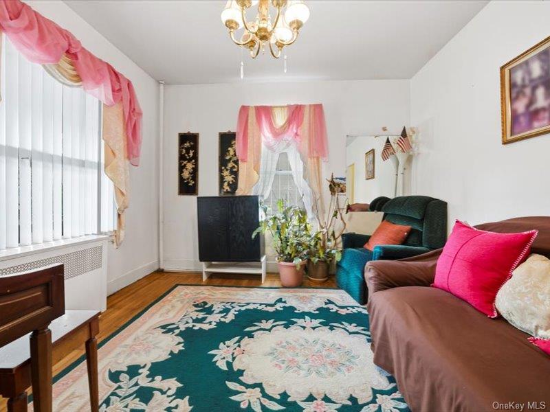 3330 Eastchester Road Bronx, NY 10469 - Photo 7 of 39 a living room with furniture and a chandelier