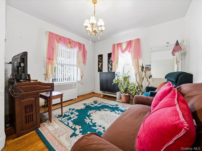 3330 Eastchester Road Bronx, NY 10469 - Photo 8 of 39 a living room with furniture and a chandelier