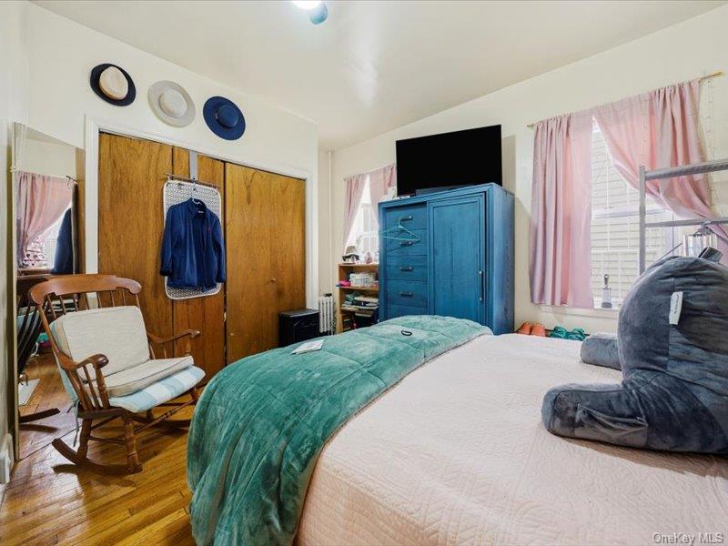 3330 Eastchester Road Bronx, NY 10469 - Photo 9 of 39 a bedroom with a bed and wooden floor