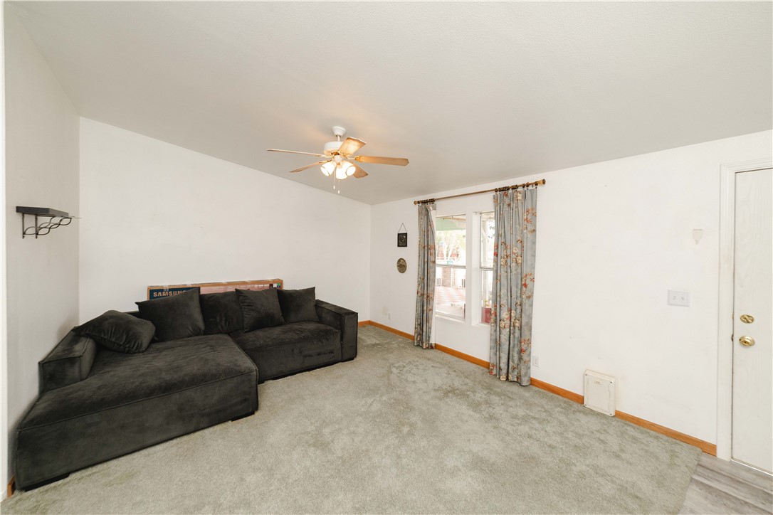 3535 Ajo Road Golden Valley, AZ 86413 - Photo 8 of 58 Carpeted living area with baseboards and a ceiling fan