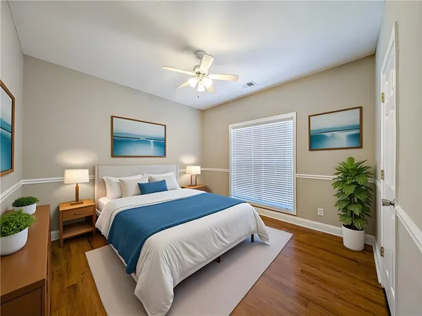a bedroom with bed and a potted plant