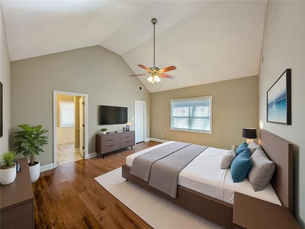 a bedroom with a bed and a flat screen tv