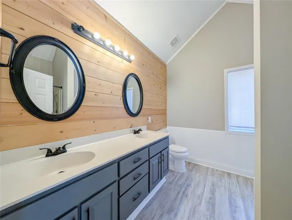 a bathroom with a double vanity sink and a mirror