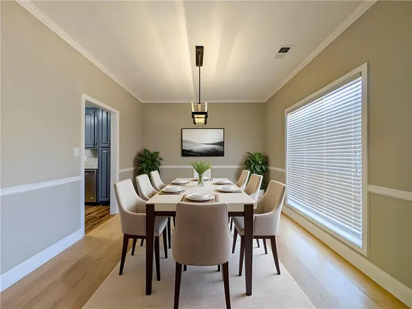 a dining room with furniture and wooden floor