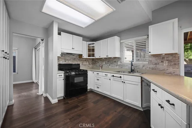 a kitchen with stainless steel appliances a refrigerator and a sink