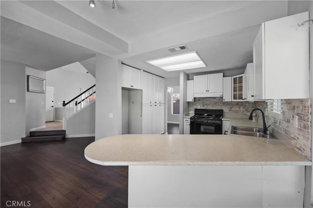 4117 East Ave R 13 Palmdale, CA 93552 - Photo 4 of 16 a kitchen with stainless steel appliances a refrigerator and a sink