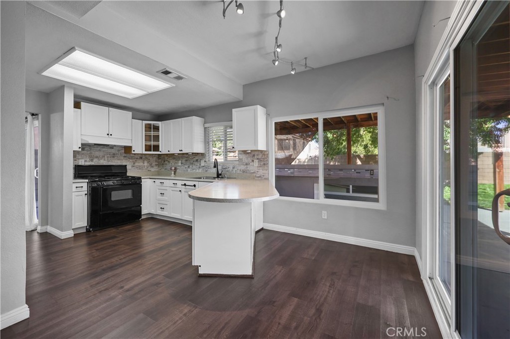 4117 East Ave R 13 Palmdale, CA 93552 - Photo 5 of 16 a kitchen with stainless steel appliances kitchen island granite countertop a stove a sink and a refrigerator
