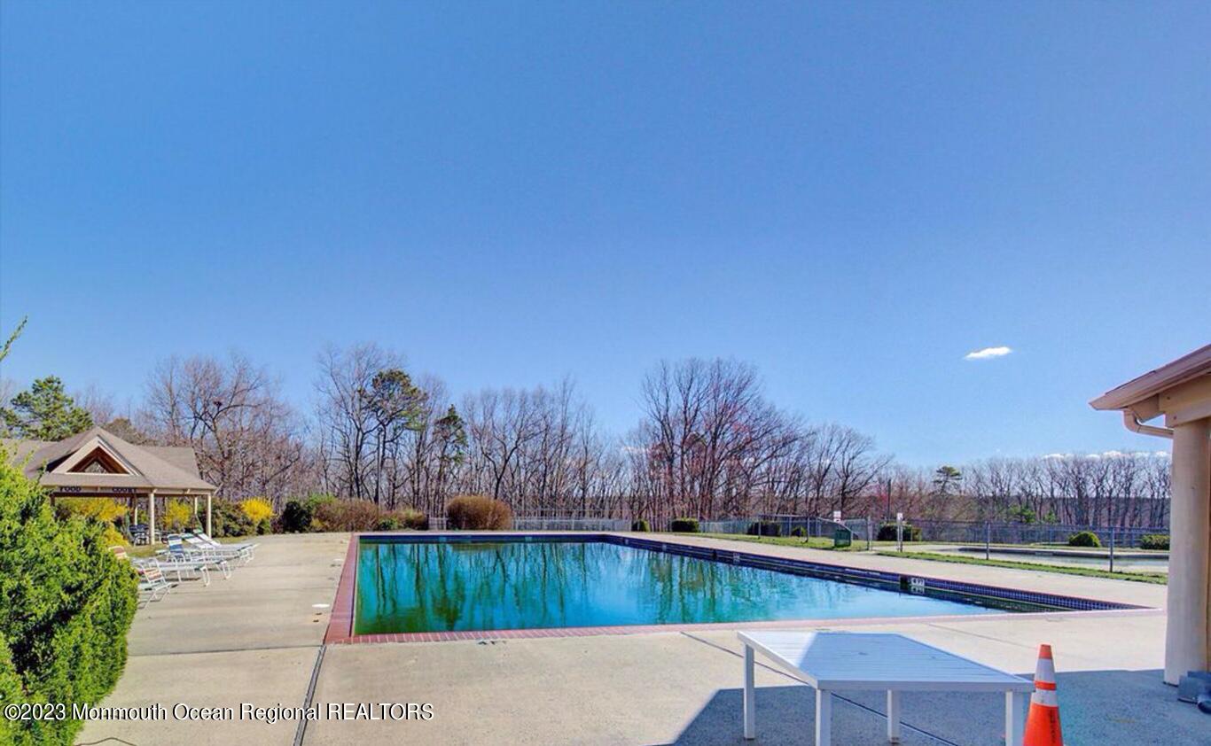 207 Violet Lane Jackson, NJ 08527 - Photo 2 of 5 a view of a swimming pool with a patio and a yard