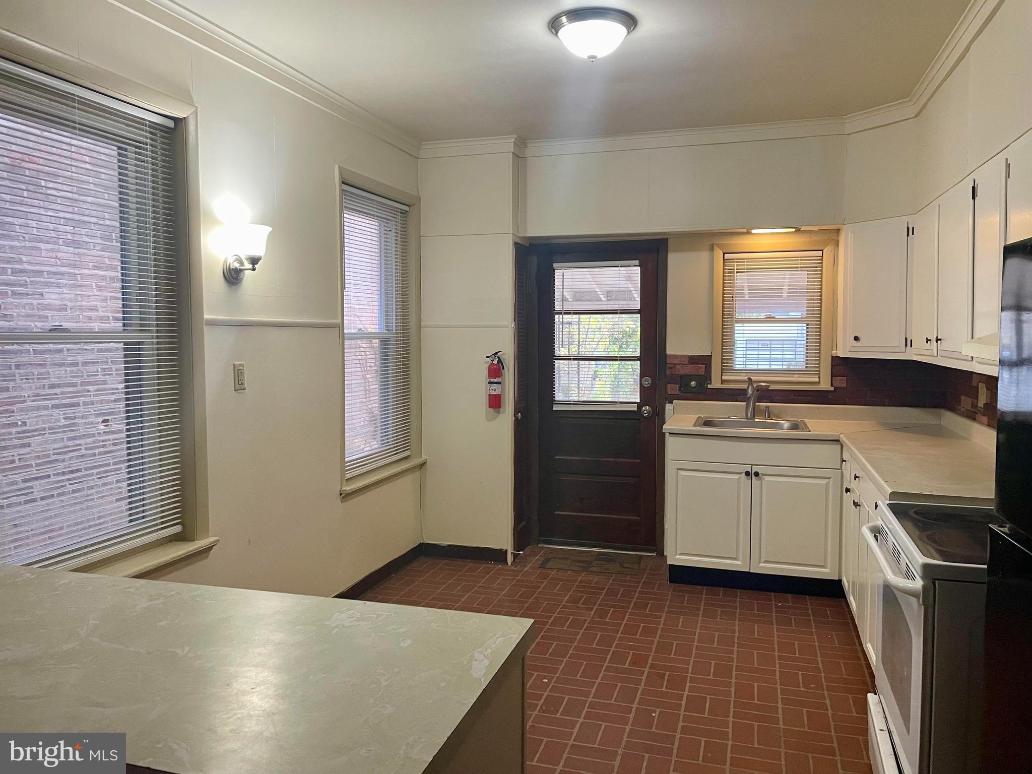 256 Beech Street Pottstown, PA 19464 - Photo 12 of 25 a kitchen with a sink a stove cabinets and wooden floor