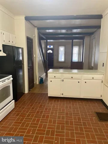 a room with a mirror and cabinets