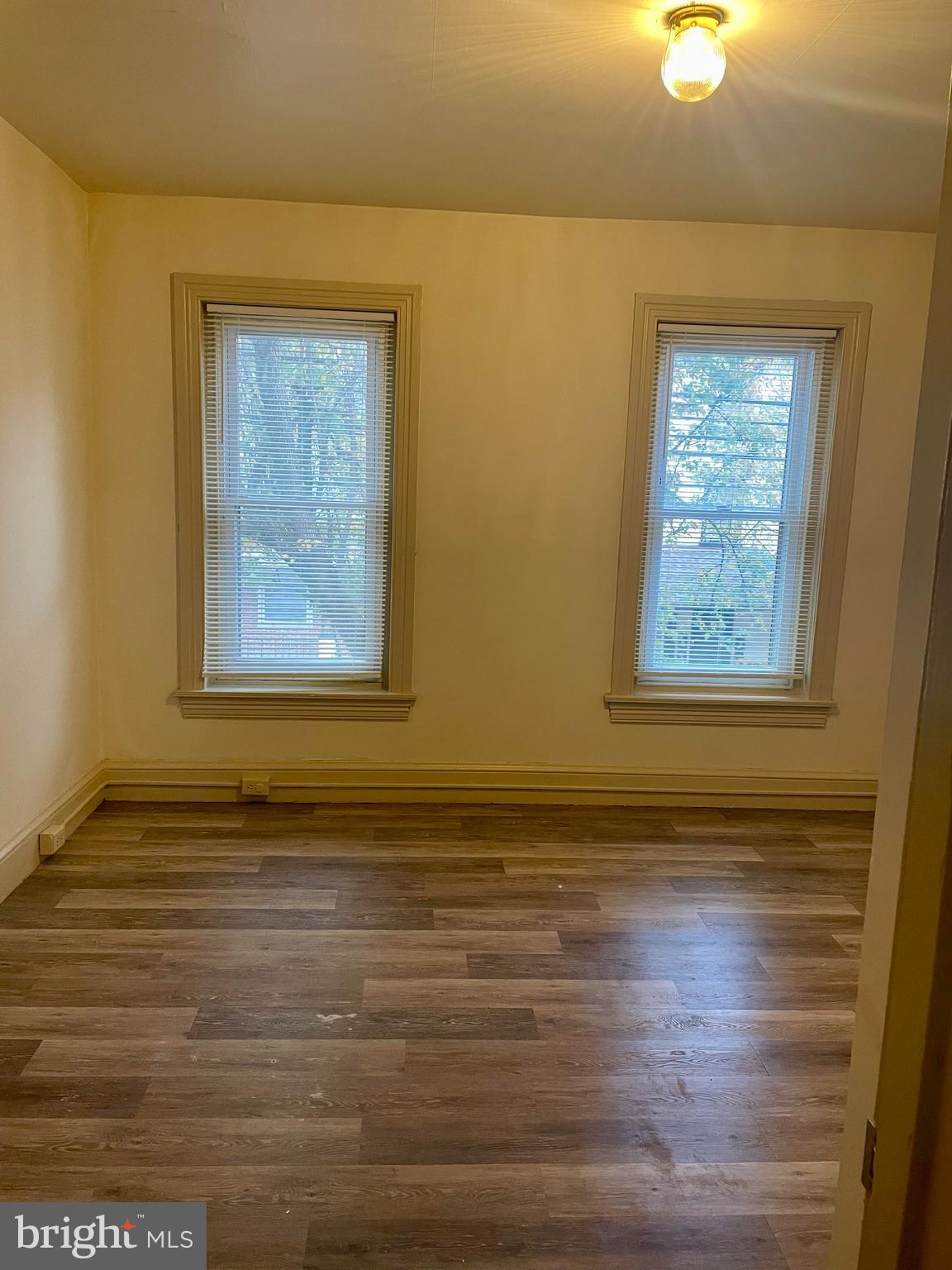 256 Beech Street Pottstown, PA 19464 - Photo 19 of 25 a view of an empty room with wooden floor and a window