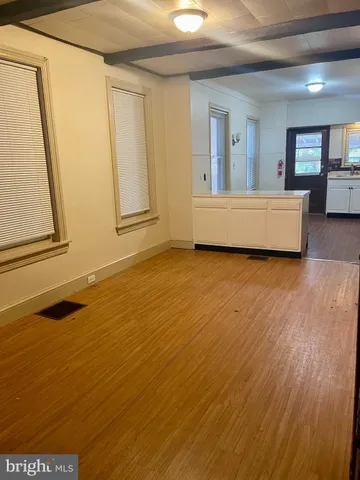 a view of an empty room with a fireplace and a window