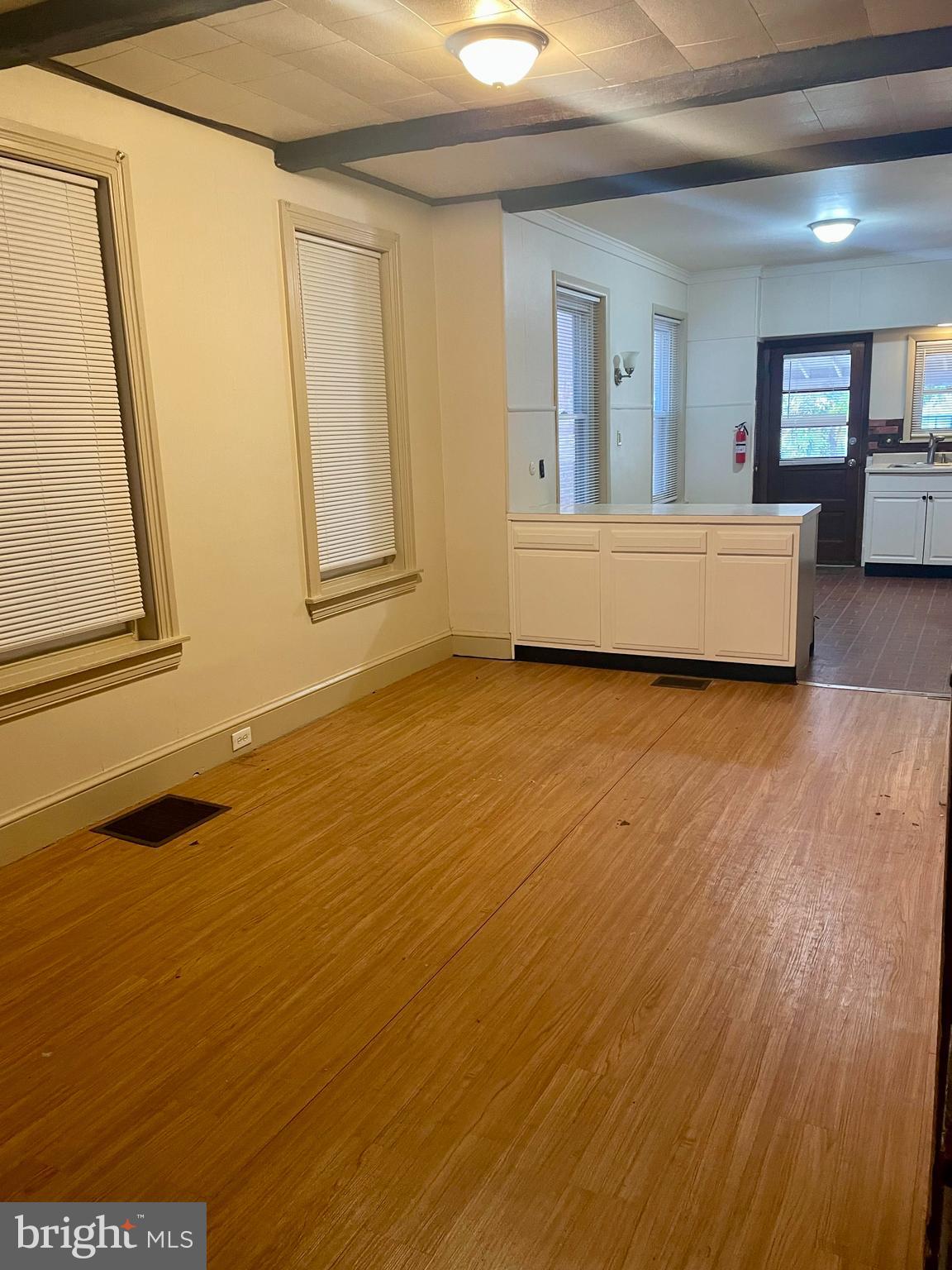 256 Beech Street Pottstown, PA 19464 - Photo 9 of 25 a view of an empty room with a fireplace and a window