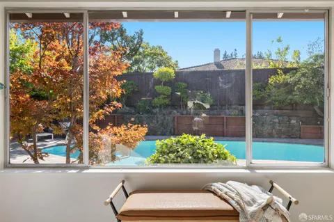 a view of a porch with furniture and floor to ceiling window