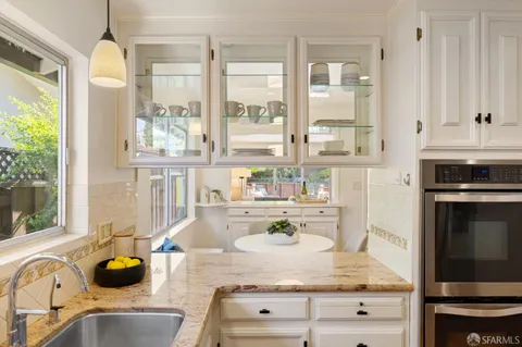 a kitchen with a stove refrigerator and microwave