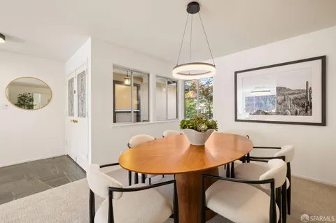 a view of a dining room with furniture and a chandelier