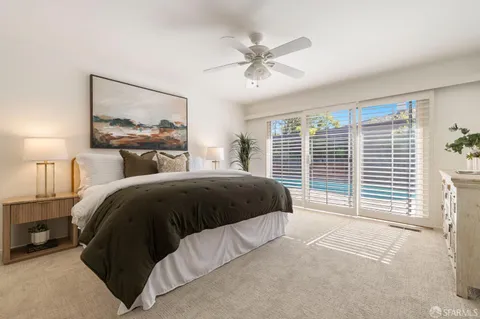 a bedroom with a large bed and a window